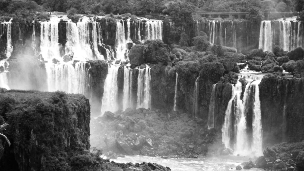 A stunning grayscale image capturing the powerful Iguazu Falls in Brazil, showcasing nature's beauty.